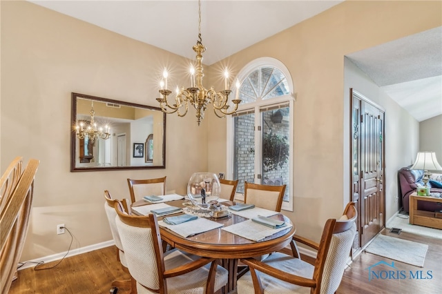 625 W Lake Ct Unit U5, Findlay, OH 45840 - dining space featuring a chandelier, wood finished floors, and lofted ceiling