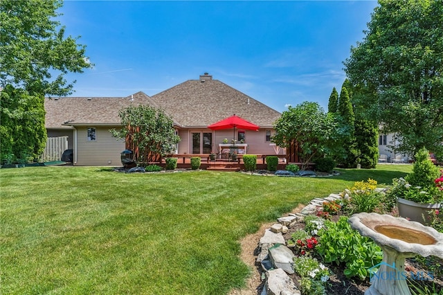 625 W Lake Ct Unit U5, Findlay, OH 45840 - back of house featuring a lawn, a shingled roof, a deck, and a chimney