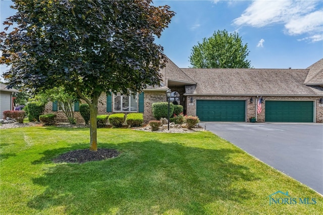 625 W Lake Ct Unit U5, Findlay, OH 45840 - view of front of property featuring brick siding, asphalt driveway, an attached garage, a front lawn, and roof with shingles