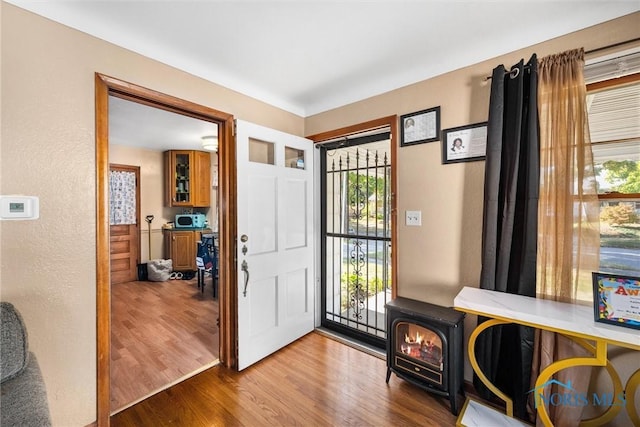721 Colima Dr, Toledo, OH 43609 - foyer entrance featuring wood finished floors, a wood stove, and a textured wall