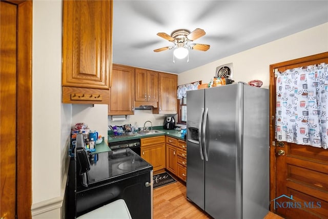 721 Colima Dr, Toledo, OH 43609 - kitchen featuring black appliances, brown cabinets, a ceiling fan, light wood-style floors, and dark countertops
