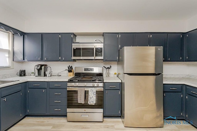 3947 Burnham Ave, Toledo, OH 43612 - kitchen featuring stainless steel appliances, light wood finished floors, and light countertops