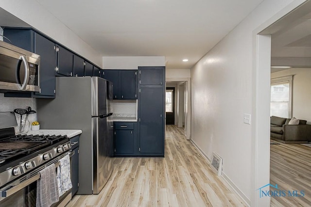 3947 Burnham Ave, Toledo, OH 43612 - kitchen with stainless steel appliances, light wood-style flooring, light countertops, recessed lighting, and blue cabinets