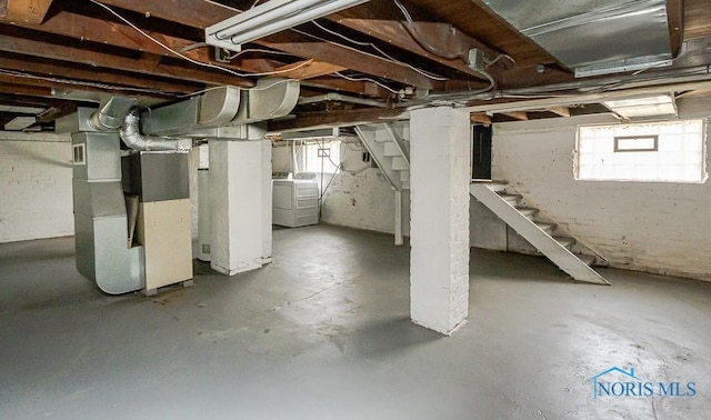 3947 Burnham Ave, Toledo, OH 43612 - below grade area with stairs, heating unit, and washing machine and clothes dryer
