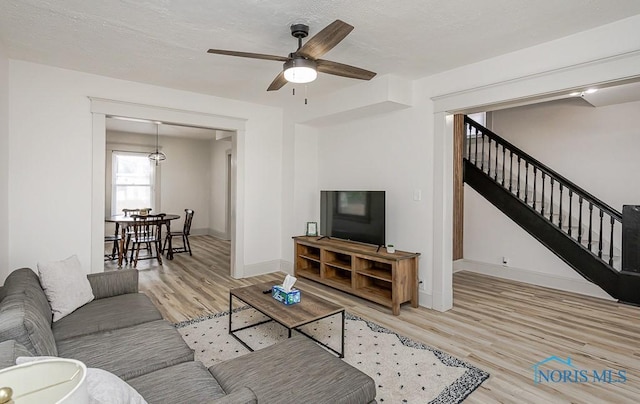 3947 Burnham Ave, Toledo, OH 43612 - living room with wood finished floors, stairs, and a ceiling fan
