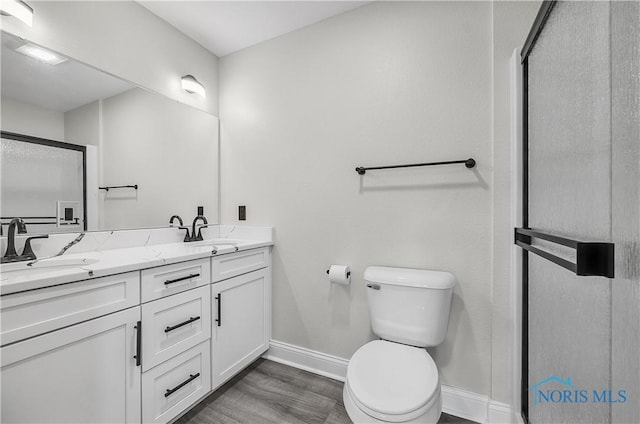 9414 Sheffield Rd, Perrysburg, OH 43551 - bathroom featuring double vanity, a stall shower, and wood finished floors