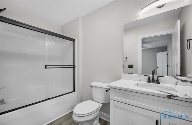 9414 Sheffield Rd, Perrysburg, OH 43551 - bathroom featuring vanity, wood finished floors, bath / shower combo with glass door, and a ceiling fan