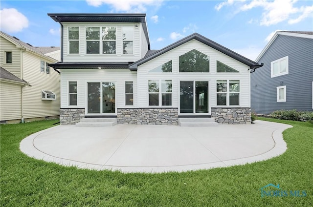 9414 Sheffield Rd, Perrysburg, OH 43551 - rear view of house featuring entry steps, stone siding, a yard, and a patio