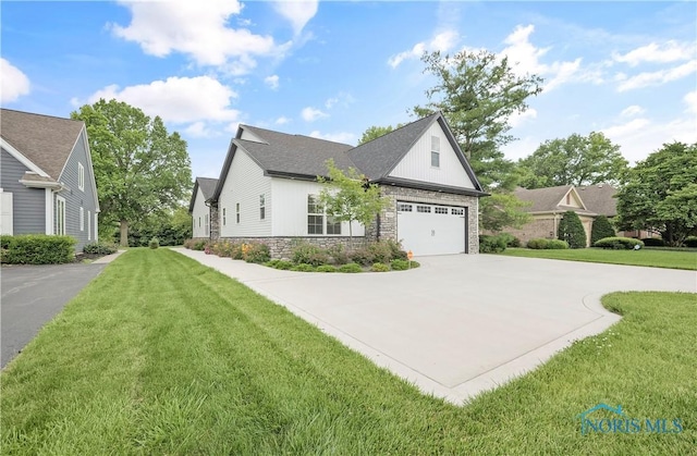 9414 Sheffield Rd, Perrysburg, OH 43551 - view of front of house featuring concrete driveway, stone siding, and a front lawn
