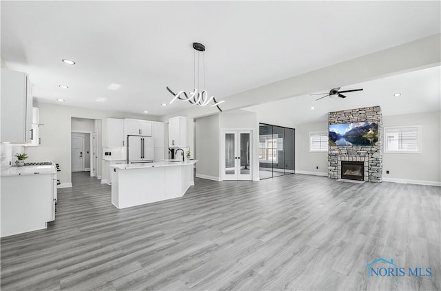 9414 Sheffield Rd, Perrysburg, OH 43551 - unfurnished living room with light wood finished floors, a ceiling fan, recessed lighting, and a fireplace