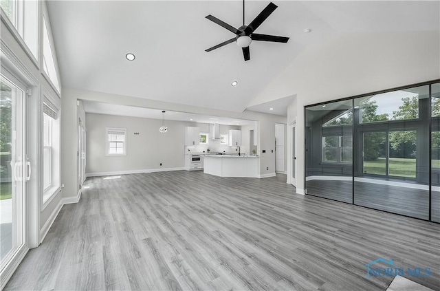 9414 Sheffield Rd, Perrysburg, OH 43551 - unfurnished living room featuring high vaulted ceiling, a ceiling fan, light wood-style flooring, and recessed lighting