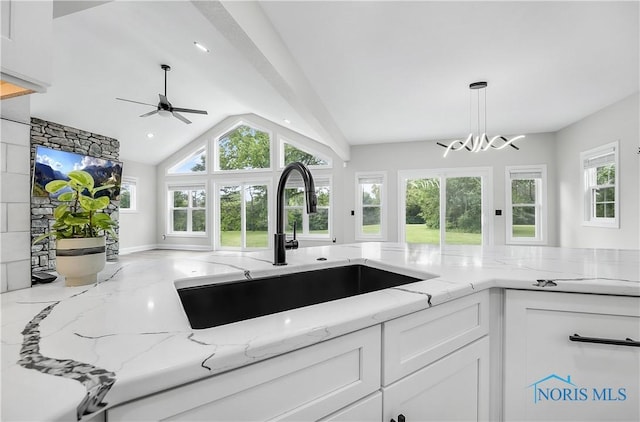 9414 Sheffield Rd, Perrysburg, OH 43551 - kitchen featuring white cabinetry, a ceiling fan, healthy amount of natural light, decorative light fixtures, and vaulted ceiling
