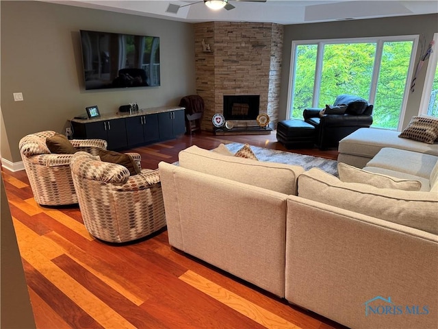 5831 Monroe St Unit 403, Sylvania, OH 43560 - living room featuring ceiling fan, wood finished floors, and a stone fireplace