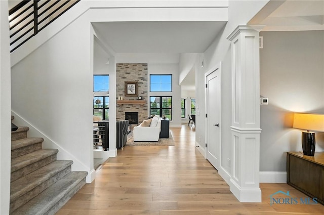 4214 Thornbury Ct, Perrysburg, OH 43551 - hall with light wood finished floors, stairway, and ornate columns