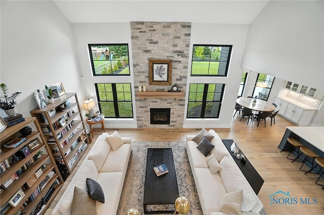 4214 Thornbury Ct, Perrysburg, OH 43551 - living room with wood finished floors, a fireplace, and a towering ceiling
