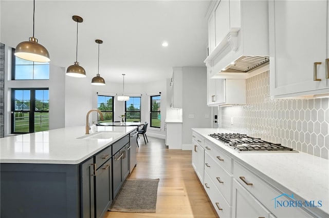 4214 Thornbury Ct, Perrysburg, OH 43551 - kitchen featuring stainless steel appliances, light wood-style floors, tasteful backsplash, white cabinetry, and recessed lighting