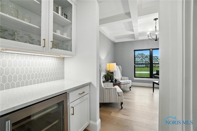 4214 Thornbury Ct, Perrysburg, OH 43551 - bar featuring wine cooler, coffered ceiling, light wood-style flooring, tasteful backsplash, and beam ceiling