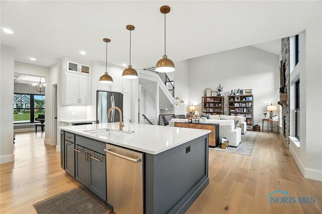 4214 Thornbury Ct, Perrysburg, OH 43551 - kitchen featuring stainless steel appliances, white cabinetry, light wood-type flooring, light countertops, and recessed lighting