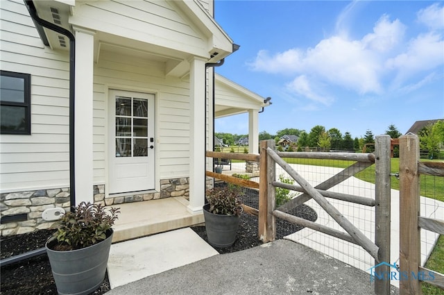 4214 Thornbury Ct, Perrysburg, OH 43551 - view of exterior entry with stone siding and a porch