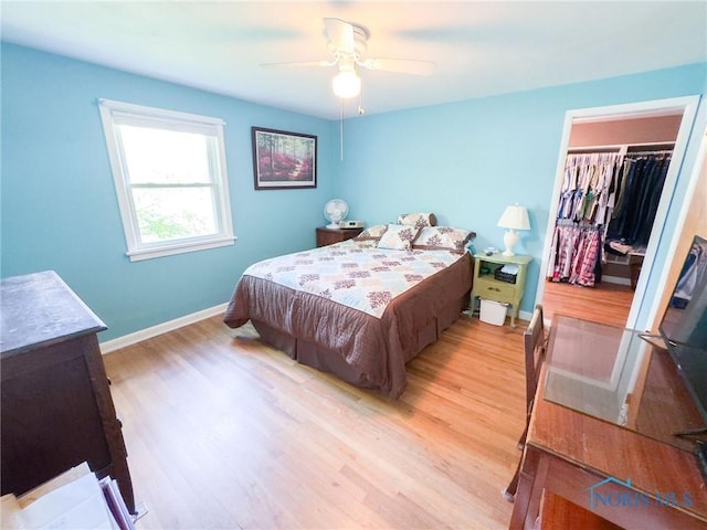 1925 Harlan Rd, Toledo, OH 43615 - bedroom with light wood-type flooring, a closet, a walk in closet, and ceiling fan