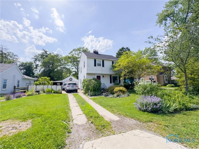 1925 Harlan Rd, Toledo, OH 43615 - colonial-style house with driveway, a chimney, and a detached garage