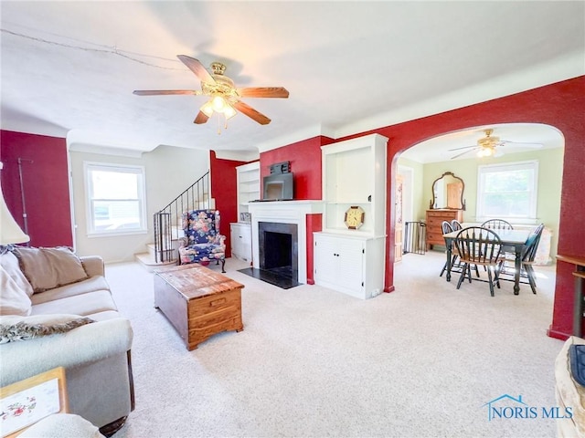 1925 Harlan Rd, Toledo, OH 43615 - living room featuring ceiling fan, arched walkways, plenty of natural light, and stairway