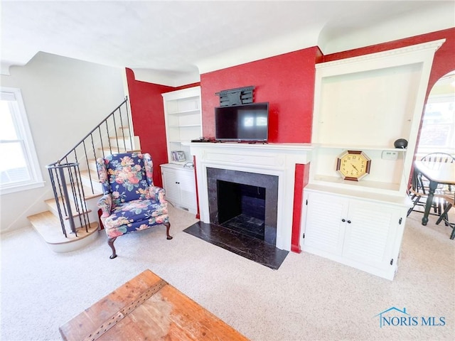 1925 Harlan Rd, Toledo, OH 43615 - living area featuring plenty of natural light, stairs, carpet flooring, and a fireplace with flush hearth