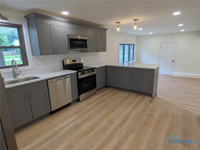 1948 Sudbury Dr, Holland, OH 43528 - kitchen with appliances with stainless steel finishes, gray cabinets, a peninsula, recessed lighting, and light countertops