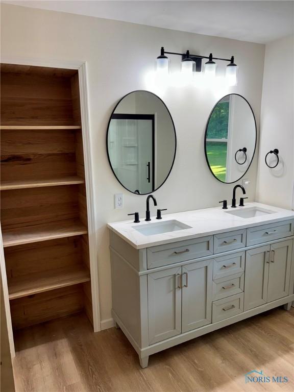 1948 Sudbury Dr, Holland, OH 43528 - bathroom with wood finished floors and double vanity