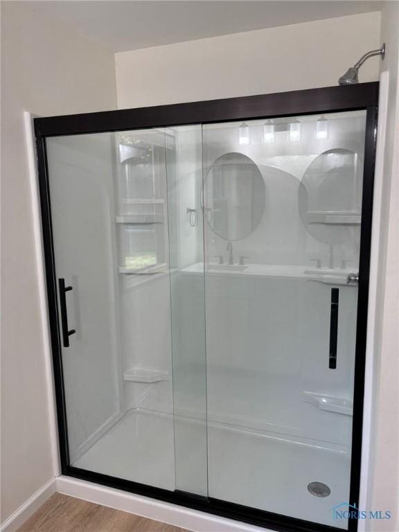 1948 Sudbury Dr, Holland, OH 43528 - bathroom featuring a shower stall and wood finished floors