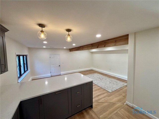 1948 Sudbury Dr, Holland, OH 43528 - kitchen with a peninsula, light wood-style floors, pendant lighting, recessed lighting, and dark cabinetry