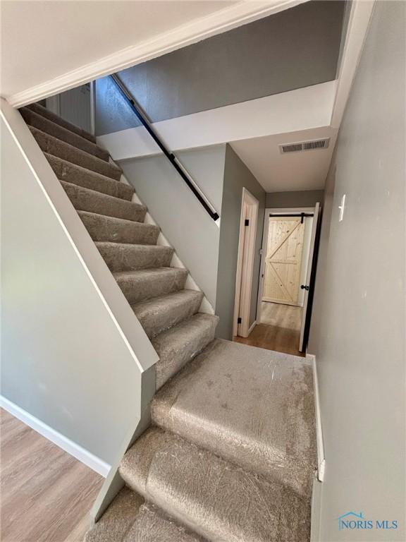 1948 Sudbury Dr, Holland, OH 43528 - stairs featuring wood finished floors