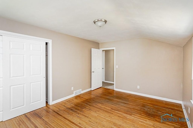 1831 Evansdale Ave, Toledo, OH 43607 - unfurnished bedroom featuring light wood-style flooring and vaulted ceiling