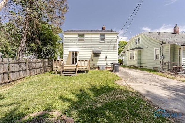 1831 Evansdale Ave, Toledo, OH 43607 - back of property with a chimney and a wooden deck