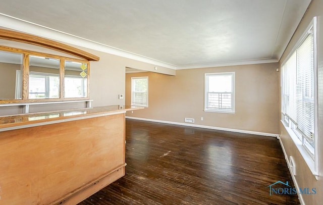 1831 Evansdale Ave, Toledo, OH 43607 - unfurnished living room featuring dark wood-style floors and ornamental molding