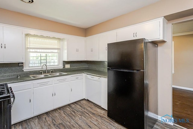 1831 Evansdale Ave, Toledo, OH 43607 - kitchen featuring freestanding refrigerator, white dishwasher, gas range oven, dark wood-type flooring, and dark countertops