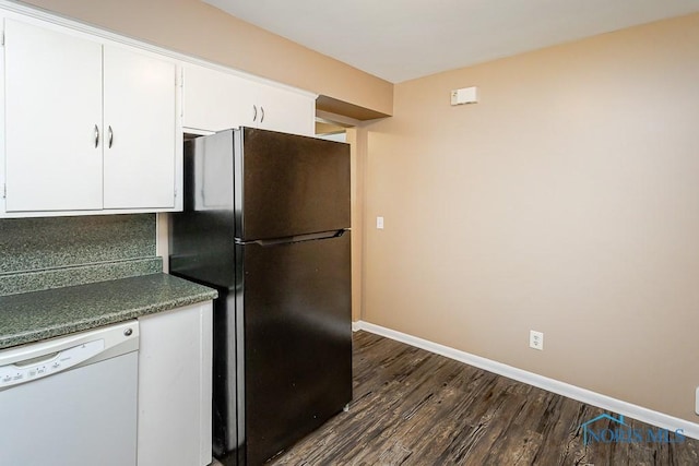 1831 Evansdale Ave, Toledo, OH 43607 - kitchen with freestanding refrigerator, white dishwasher, dark wood-style floors, white cabinetry, and dark countertops