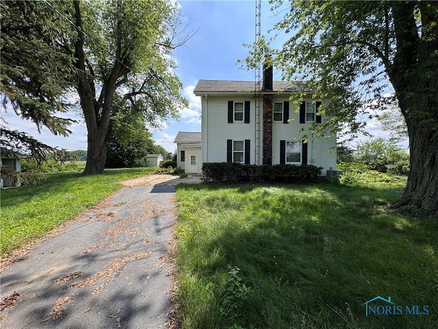 0 Old State Line Rd, Swanton, OH 43558 - colonial-style house with driveway, a chimney, and a front yard