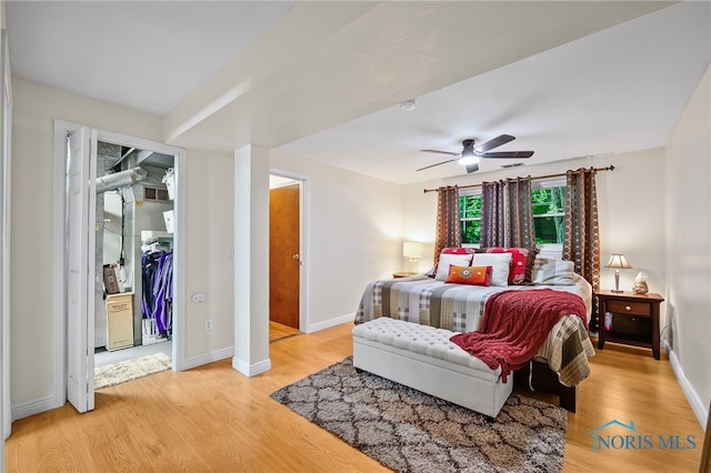 6961 Convent Blvd, Sylvania, OH 43560 - bedroom featuring light wood-type flooring, ceiling fan, and a walk in closet