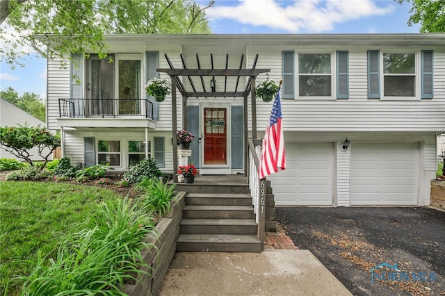6961 Convent Blvd, Sylvania, OH 43560 - split foyer home with an attached garage, asphalt driveway, a pergola, and a balcony