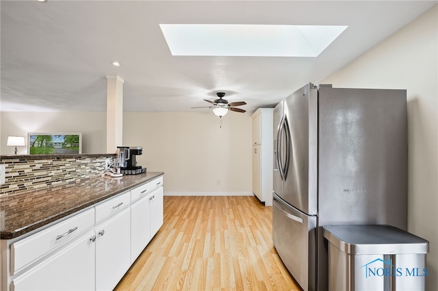 6961 Convent Blvd, Sylvania, OH 43560 - kitchen featuring freestanding refrigerator, a skylight, decorative backsplash, white cabinets, and recessed lighting