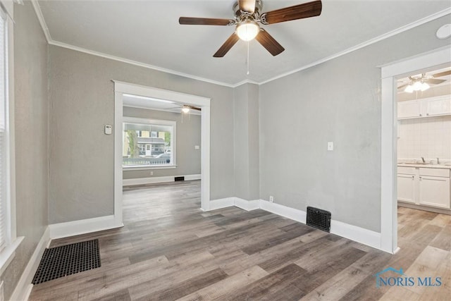 436 Danberry St, Toledo, OH 43609 - empty room featuring a ceiling fan, light wood-type flooring, and ornamental molding
