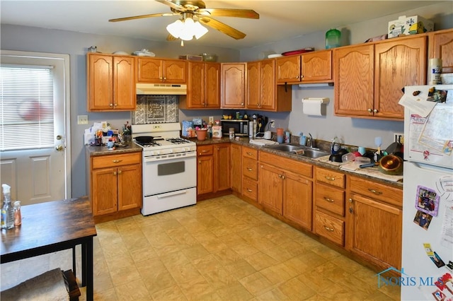 912 Virginia St, Port Clinton, OH 43452 - kitchen with white appliances, under cabinet range hood, ceiling fan, and brown cabinetry