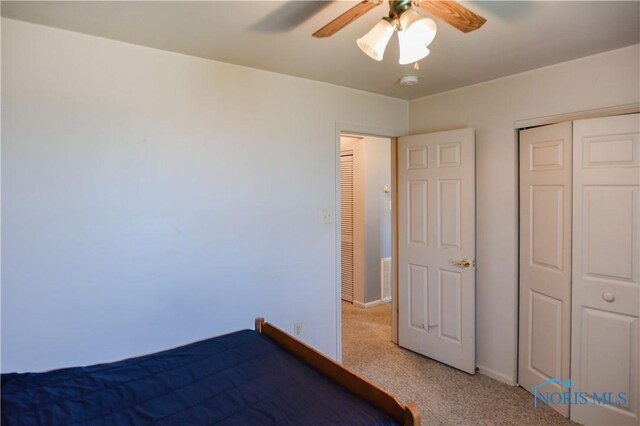 912 Virginia St, Port Clinton, OH 43452 - unfurnished bedroom featuring light colored carpet, a closet, and ceiling fan
