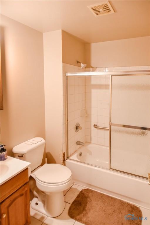 912 Virginia St, Port Clinton, OH 43452 - bathroom with vanity, tile patterned floors, and enclosed tub / shower combo