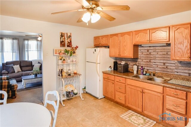 912 Virginia St, Port Clinton, OH 43452 - kitchen with freestanding refrigerator, a ceiling fan, light brown cabinets, and backsplash