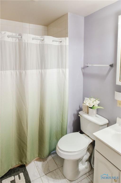 912 Virginia St, Port Clinton, OH 43452 - full bath featuring vanity, curtained shower, and tile patterned flooring