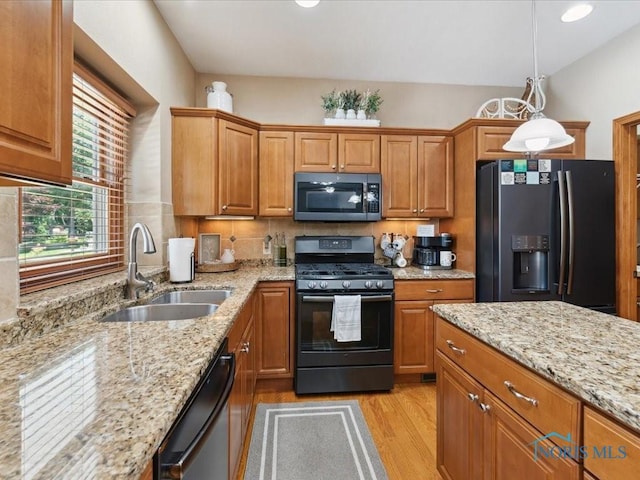 646 Whisperlake Rd, Holland, OH 43528 - kitchen with fridge with ice dispenser, black gas range oven, stainless steel microwave, dishwashing machine, and light wood-style floors