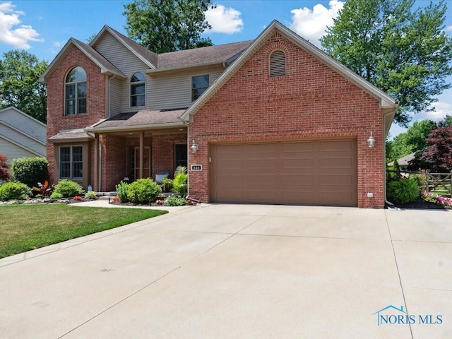 646 Whisperlake Rd, Holland, OH 43528 - traditional home featuring brick siding, driveway, an attached garage, and a front lawn