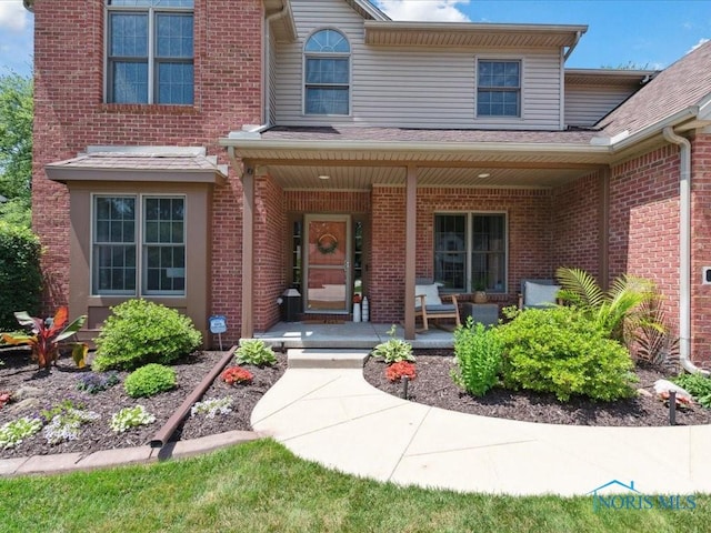 646 Whisperlake Rd, Holland, OH 43528 - view of exterior entry featuring covered porch, brick siding, and a shingled roof